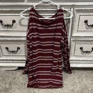 Long sleeve open shoulder shirt. It’s not red, it’s maroon